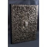 A leather stationery folder with pierced and embossed silver cover in the form of c scrolls and