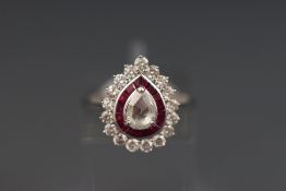 An 18ct white gold pear shaped diamond and ruby cluster ring.