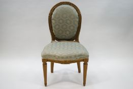 A French style gilded side chair with duck egg blue patterned upholstery on fluted legs