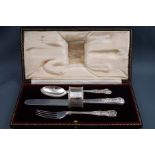 A silver Kings pattern knife, fork and spoon, and silver napkin ring, London 1913, 6oz gross,