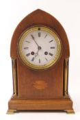 An Edwardian mahogany mantel clock of lancet shape, the eight day movement striking on a bell,