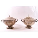 A pair of EPNS two handled sauce tureens and covers, heavily engraved with Rococo style decoration,