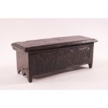 A doll's house oak coffer with carved decoration to front and back and interior divider,