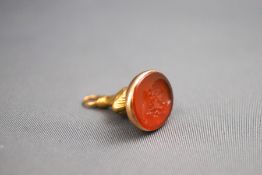 A gold mounted carved carnelian seal fob. Tests indicate 9ct gold. 4.