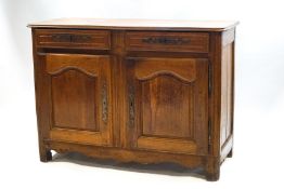 An 18th century Continental walnut credenza, two drawers over a cupboard base,