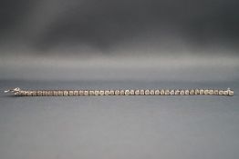 A modern white metal diamond line bracelet set with forty three round brilliant cut diamonds