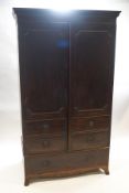A 19th century mahogany double wardrobe with faux drawer door and drawer to base on splay feet,
