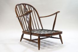 A 1960s Ercol stick back armchair with Prince of Wales feathers design to splat