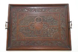 A Victorian mahogany rectangular tray with brass handles, carved with ivy and flowers in relief,