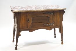 A Victorian mahogany washstand with side rails and a red and grey variegated marble top,