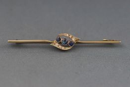 A Victorian bar brooch set with sapphires and diamonds. Pin and hook clasp. Stamped 15ct & 18ct. 3.