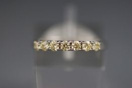 A white metal half hoop diamond ring. Stated total weight of 0.49ct.