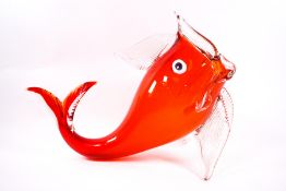 A Murano orange glass fish with mouth wide open,