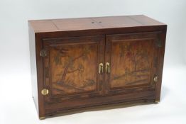 A Chinese hardwood buffet with carved and stained decoration of trees and plants,