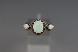 A sterling silver ring set with synthetic opal and marcasite. Size: P 4.
