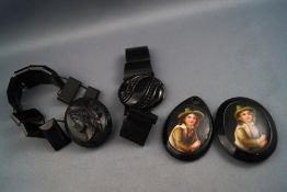 Two jet bracelets and two pendants, set with Berlin portrait plaques. Gross weight: 108.