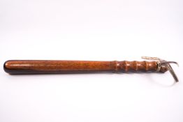 An early 20th century lignum vitae truncheon, stamped L.C.C.