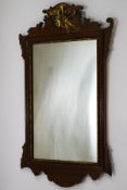A George III style mahogany wall mirror, surmounted by a gilded Ho Ho bird, 69.5cm high x 37.