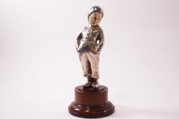 An early 20th century Continental silvered bronze and ivory figure of a boy with his hands in his