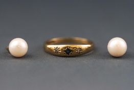 A yellow metal three stone sapphire and diamond gypsy ring, Hallmarked 9ct gold,