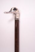 A slim ladies walking stick with white metal duck's head handle and inset blue glass eyes