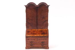 An Aspreys burr wood doll's house bureau cabinet, in the 18th century style,