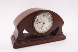 An Edwardian mahogany mantel clock of eye shape, the dial signed Walker and Hall,