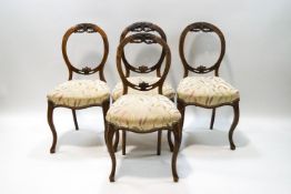 A set of four Victorian mahogany dining chairs on cabriole legs,