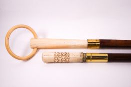 A pair of early 20th century ladies walking canes, one with a carved bone handle,
