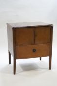 A George III mahogany bow front commode with cupboard doors, on square tapering legs,