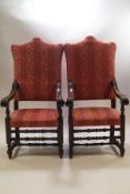 A pair of Victorian oak throne chairs, heavily carved scroll arms on turned and block supports,