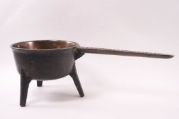An 18th century Wasbrough bronze skillet on three legs,