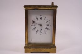 A 19th century French brass carriage clock, stamped Aiguilles, striking on a gong,