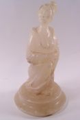 A Japanese carved hardstone figure of a kneeling Geisha on a circular stepped base,