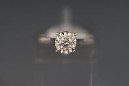 A white metal illusion set diamond solitaire ring. Stated weight of 0.27 carats.