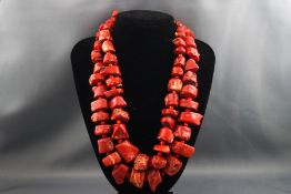 Two large abstract shaped natural coral necklaces with silver clasps.