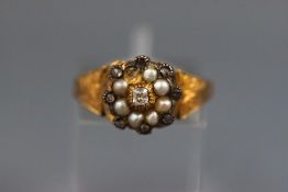 A Victorian yellow metal pearl and diamond cluster mourning ring.