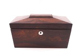 A 19th century rosewood tea caddy of sarcophagus shape and with ring handles,