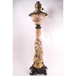 A Victorian porcelain and spelter mounted oil lamp, painted with thistles and gilt highlights,