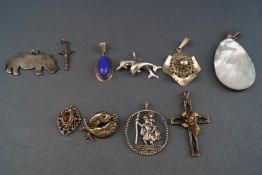A selection of ten silver pendants consisting of a large mother of pearl shell,
