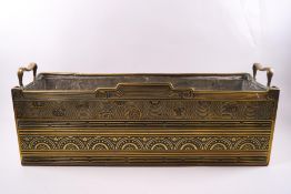 A late Victorian Aesthetic brass two handled planter with lead liner, 21cm high x 54cm wide x 17.