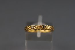 A yellow metal carved sapphire and diamond eternity ring (some stones missing) Hallmarked 18ct gold.