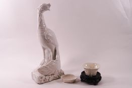 A Chinese blanc de chine porcelain figure of a peacock, 30cm high,