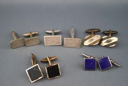 A selection of five pairs of silver cufflinks of variable designs.