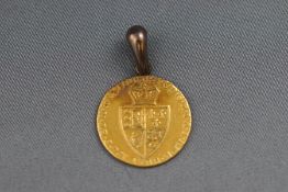 A 1788 George III spade guinea coin with attached (soldered) yellow metal pendant bale. Weight: 9.