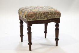 A Victorian mahogany stool with shaped apron on turned legs,