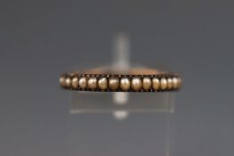 A half hoop seed pearl ring. Tests indicate 9ct gold (minimum) Size: N 1.