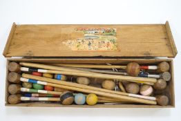 An early 20th century French croquet set with original paper label to inside of lid, eight mallets,