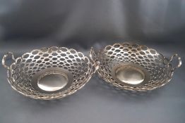 A pair of silver round bowls each with two loop handles, Birmingham 1908, 20.