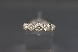 A white metal graduated diamond ring. Set with five round brilliant cut diamonds measuring from 4.